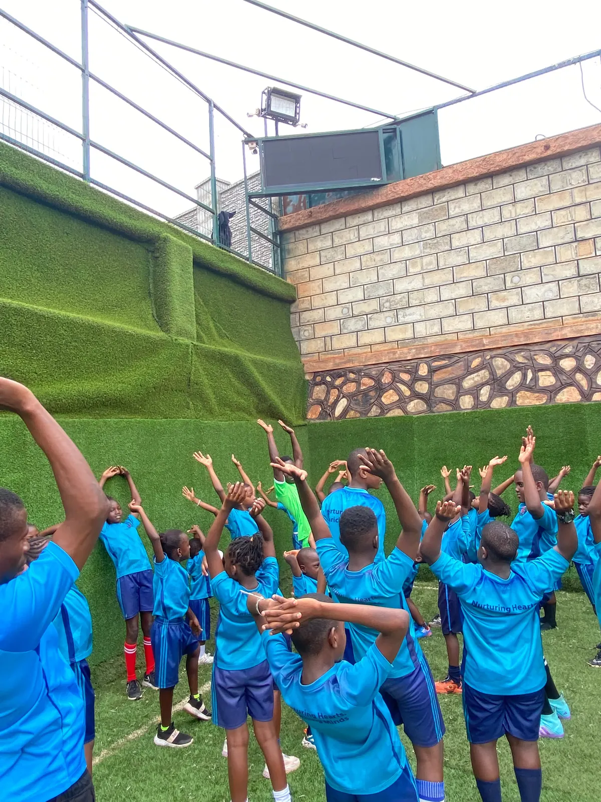 Learners playing football together